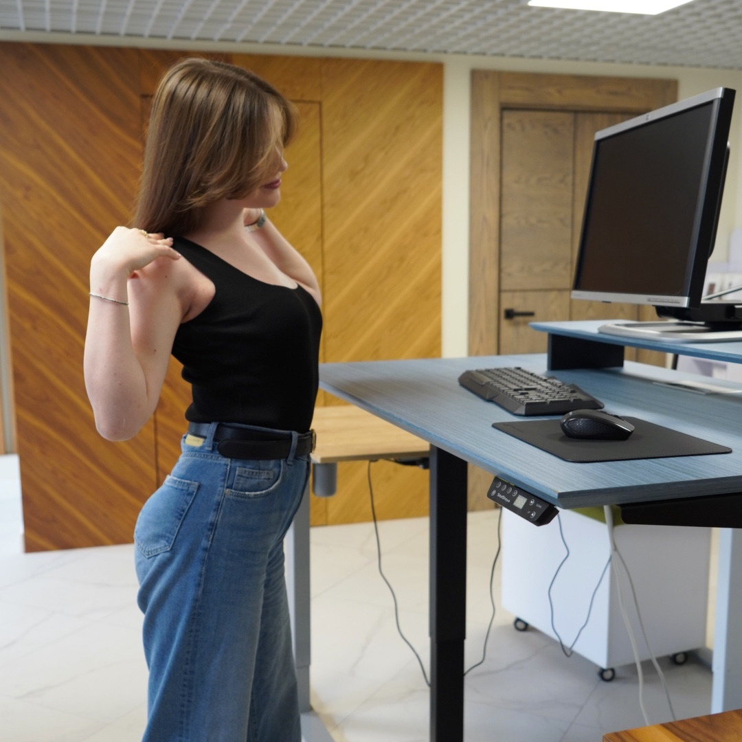 Desk with lumbar cushion, laptop stand, and ergonomic keyboard